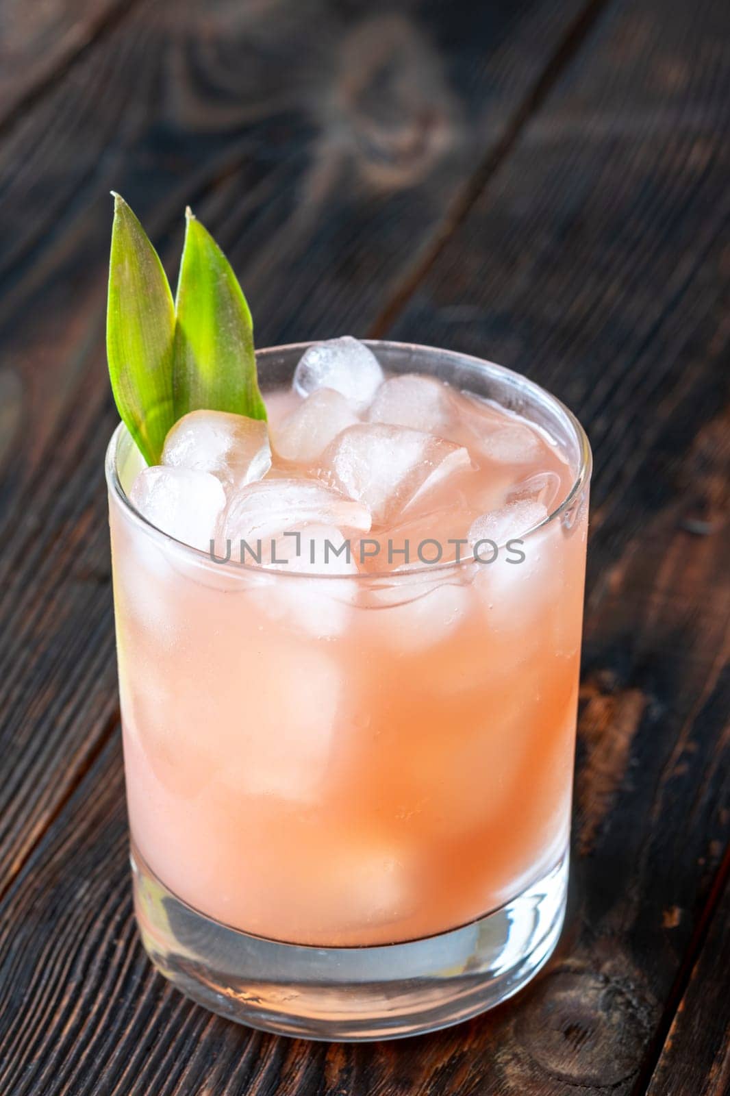 Vibrant drink blends guava, pineapple, lime, and rum in rich tropical harmony