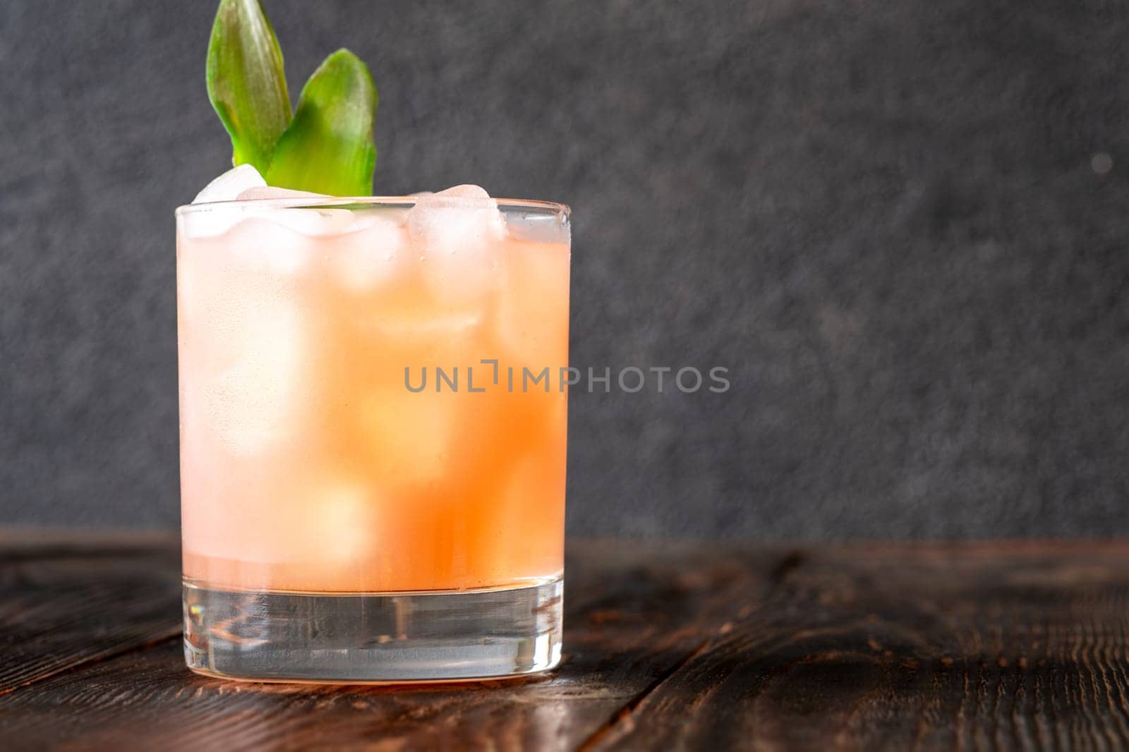 Vibrant drink blends guava, pineapple, lime, and rum in rich tropical harmony
