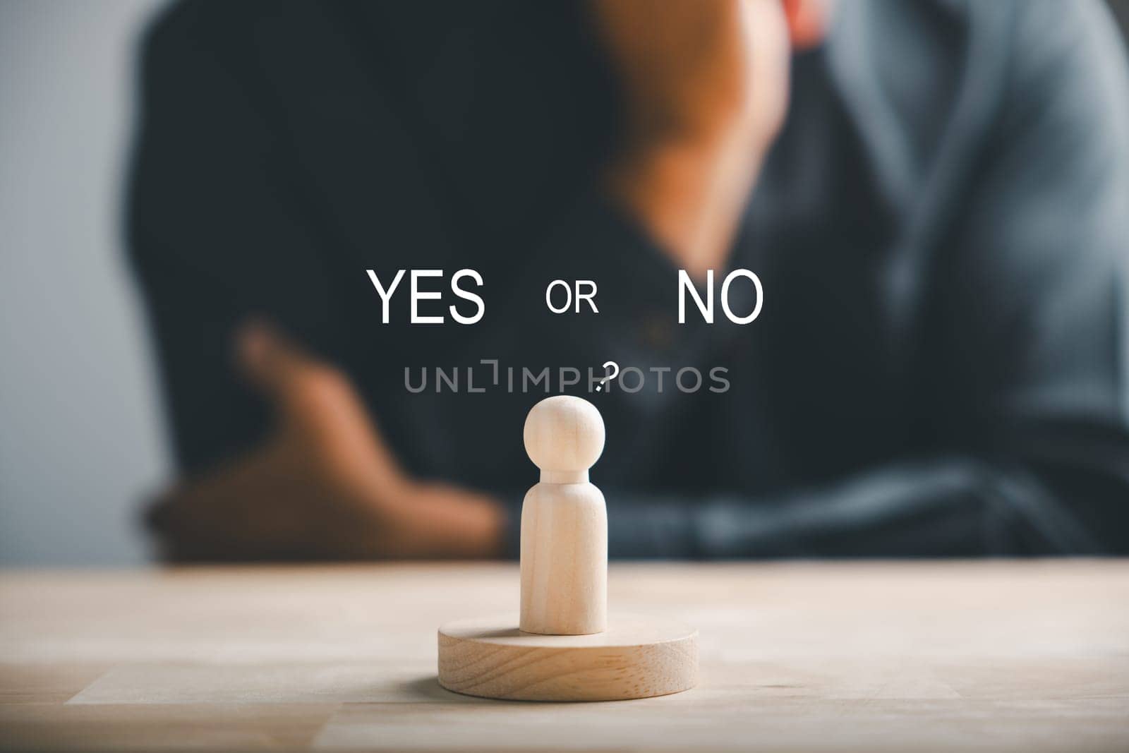 Wooden cube with peg dolls, yes or no choices in business. Man's hand holds two options emphasizing decision-making. Red question mark reinforces the concept. Think With Yes Or No Choice.
