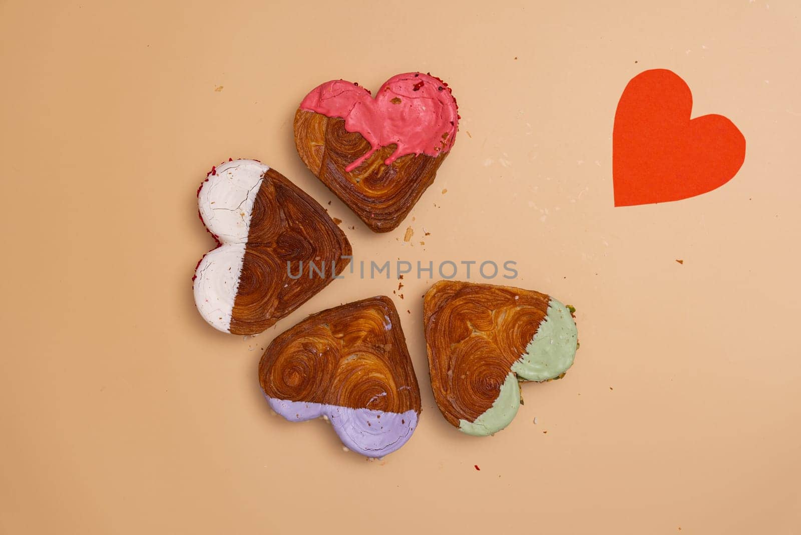 Flat lay greeting card Valentine's Day Delicious fresh variety croissants topped with colorful flavor Ganache. Creation unique heart shape bakery. Puff pastry holiday love gift present idea. Copy space