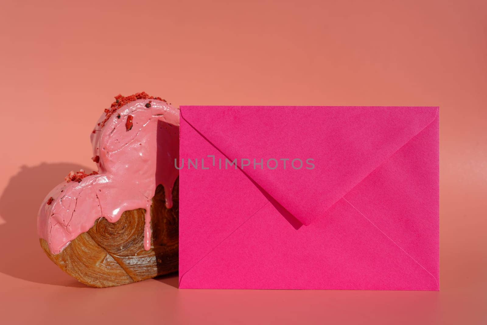 Empty sample template paper note greeting card Delicious fresh croissant topped with colorful flavor Ganache. Creation unique heart shape bakery. Puff pastry holiday love gift present idea Valentine's day. Copy space