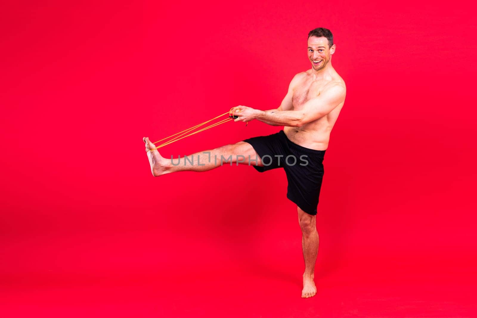 Portrait, happy man and bodybuilder with abs on a studio background, backdrop and topless pride