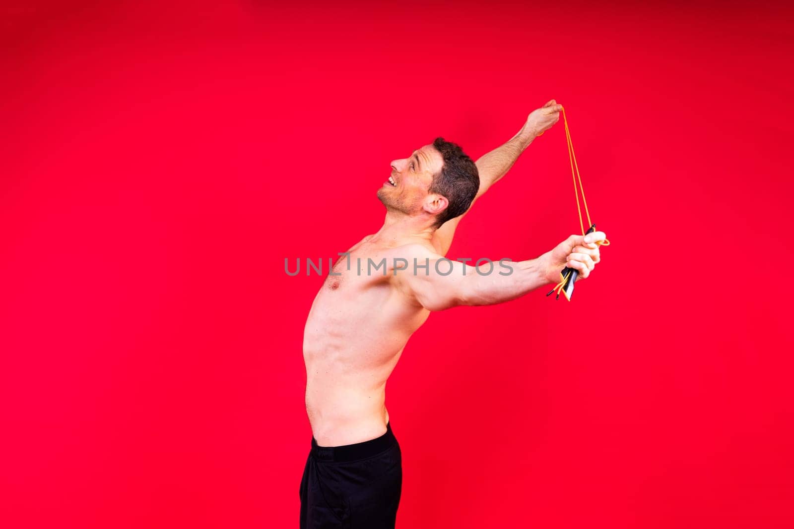 Portrait, happy man and bodybuilder with abs on a studio background, backdrop and topless pride