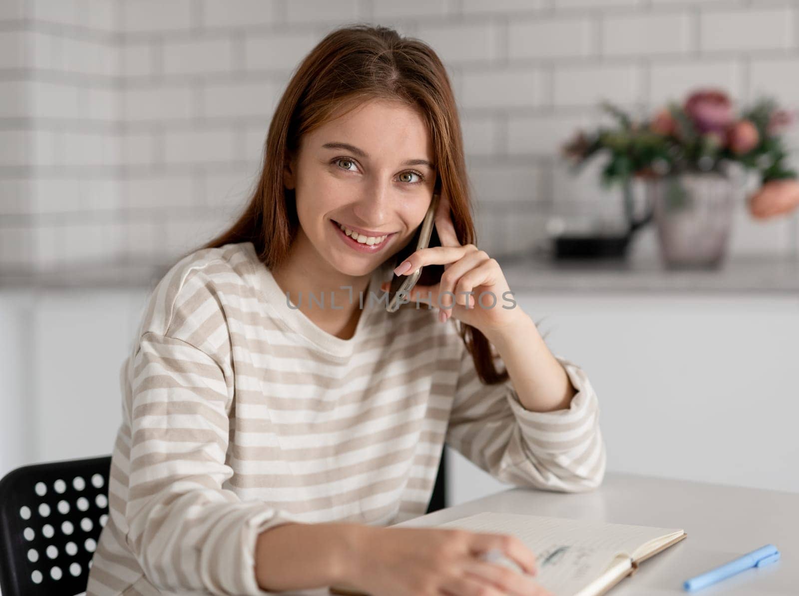 Girl Smiling While Talking On The Phone At Home
