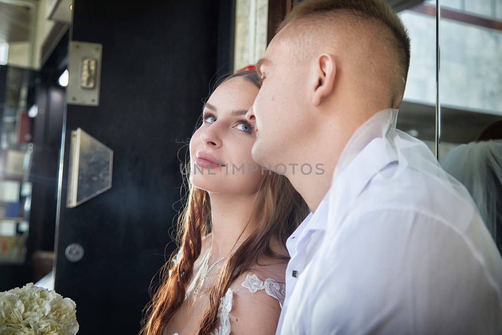 Groom and bride enjoying a cherished moment while celebrating their wedding registration together in a cozy setting.