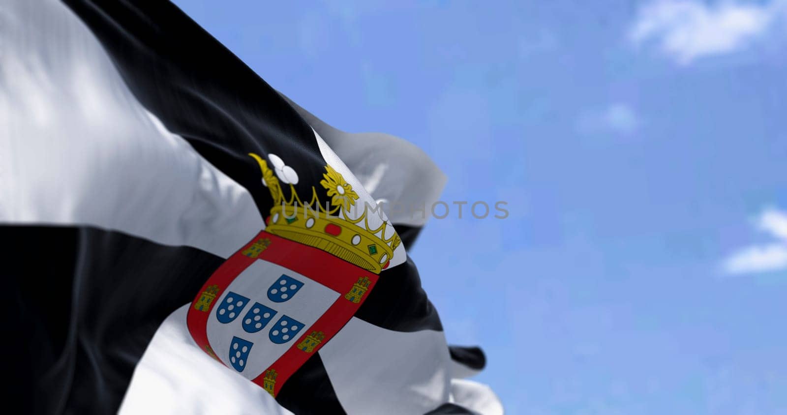 Ceuta flag waving. Ceuta is a Spanish autonomous city. Black and white gyronny with central escutcheon displaying the municipal coat of arms. 3d illustration render. Selective focus. Close-up