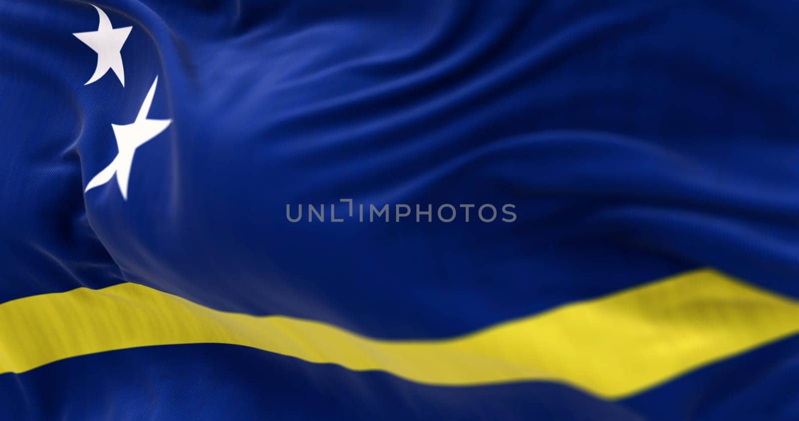 Curacao flags waving in the wind. Island and constituent country within the Kingdom of the Netherlands. Seamless 3d render animation. Slow motion loop. Selective focus