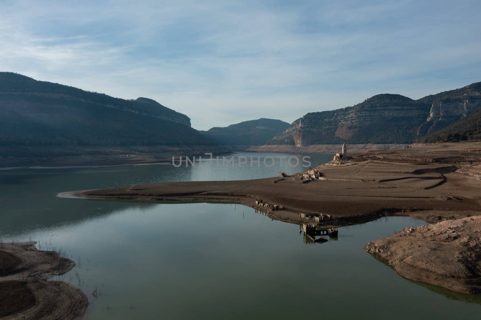 Aerial view dry and cracked earth in the reservoir at Sau reservoir, Catalonia