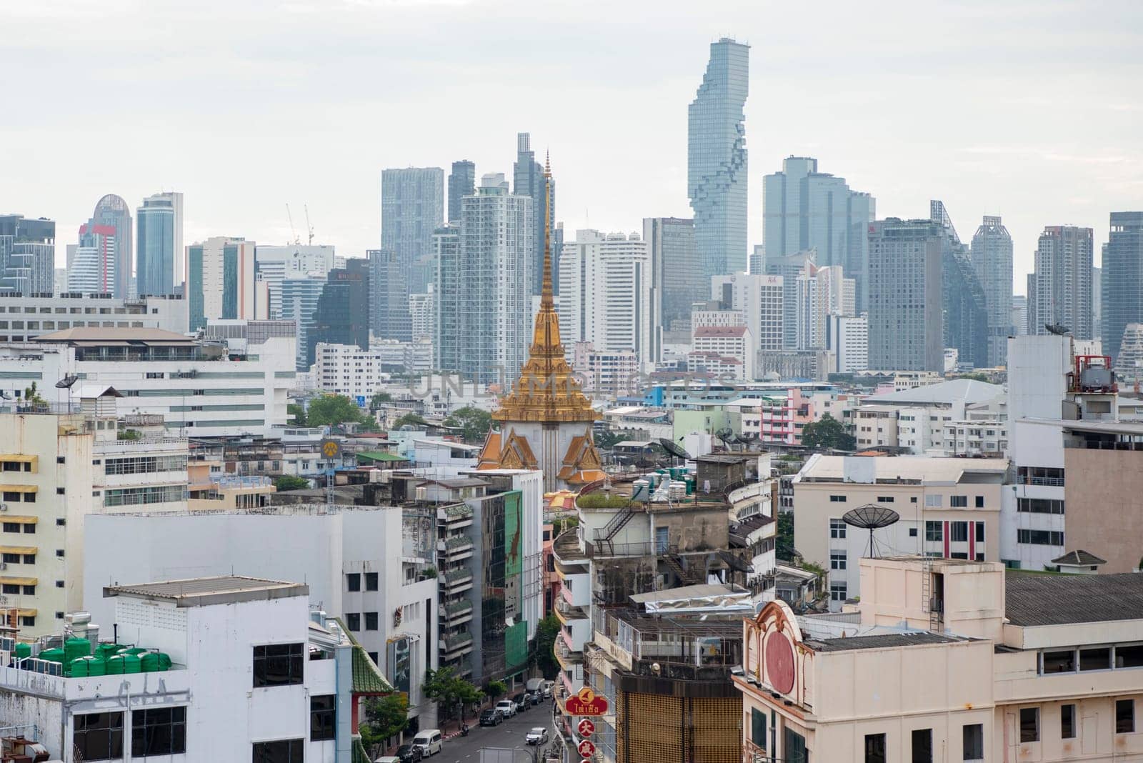Wat Traimit in Chinatown with skyline in the City of Bangkok in Thailand.  Thailand, Bangkok, November, 5, 2024.