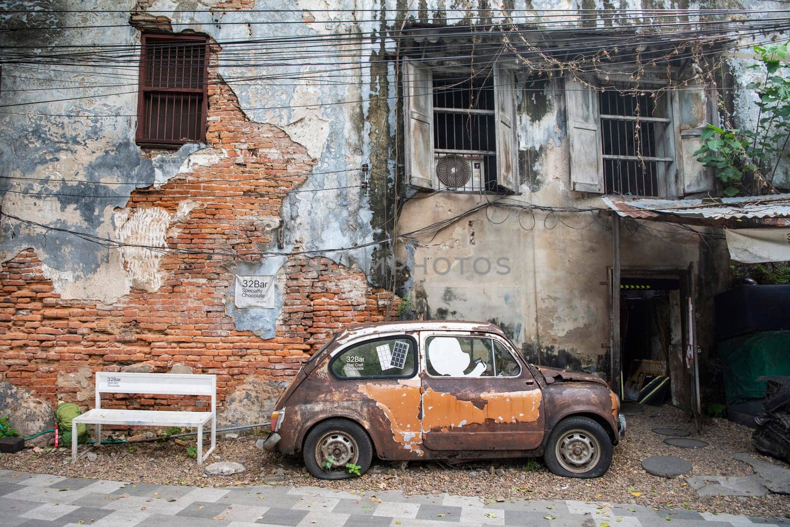 a old car in a alley in Talat Noi at China Town in City of Bangkok in Thailand.  Thailand, Bangkok, November, 5, 2024.