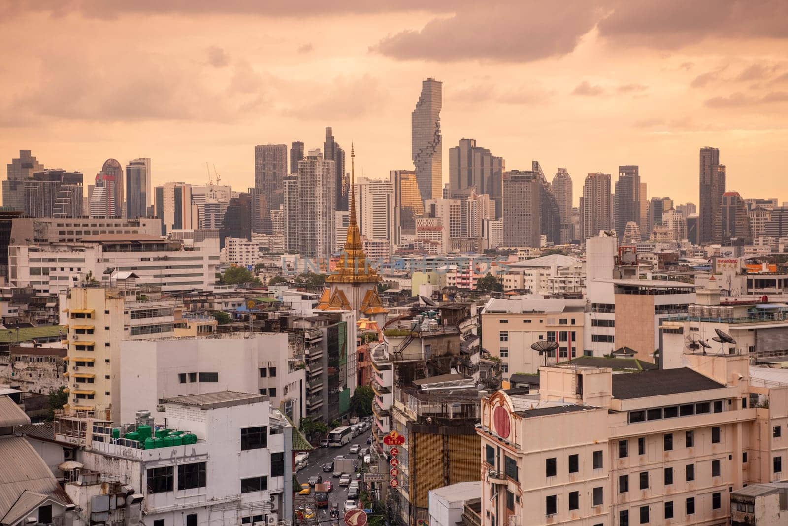 Wat Traimit in Chinatown with skyline in the City of Bangkok in Thailand.  Thailand, Bangkok, November, 5, 2024.