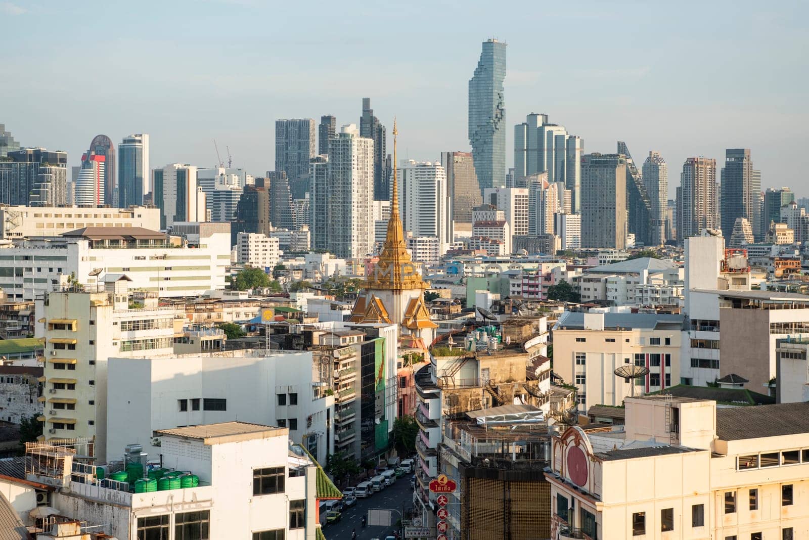 Wat Traimit in Chinatown with skyline in the City of Bangkok in Thailand.  Thailand, Bangkok, November, 6, 2024.