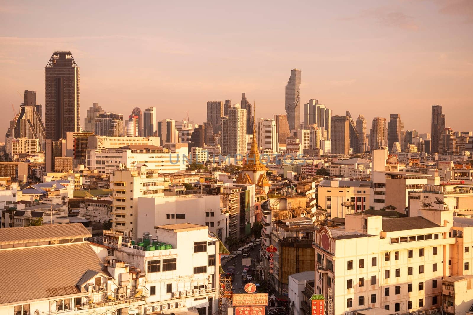 Wat Traimit in Chinatown with skyline in the City of Bangkok in Thailand.  Thailand, Bangkok, November, 6, 2024.