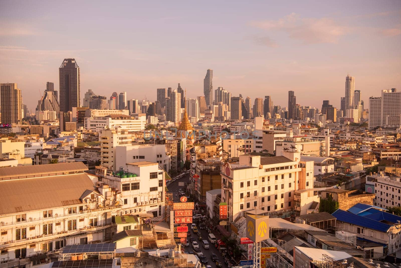 Wat Traimit in Chinatown with skyline in the City of Bangkok in Thailand.  Thailand, Bangkok, November, 6, 2024.