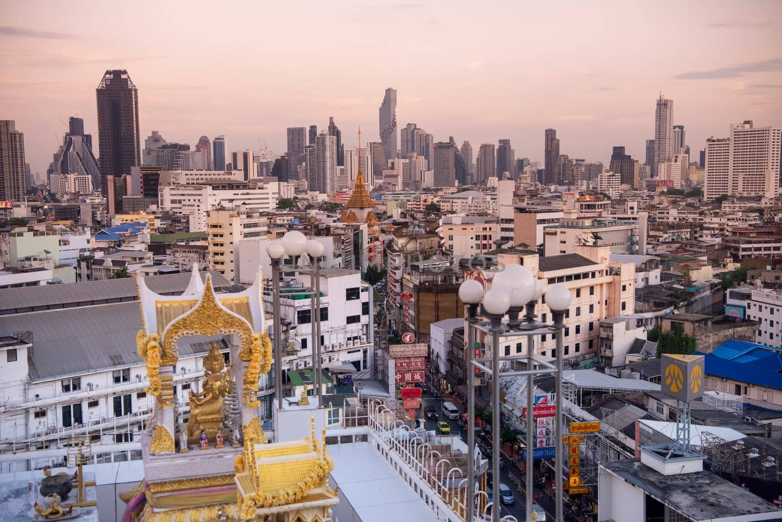 Wat Traimit in Chinatown with skyline in the City of Bangkok in Thailand.  Thailand, Bangkok, November, 6, 2024.