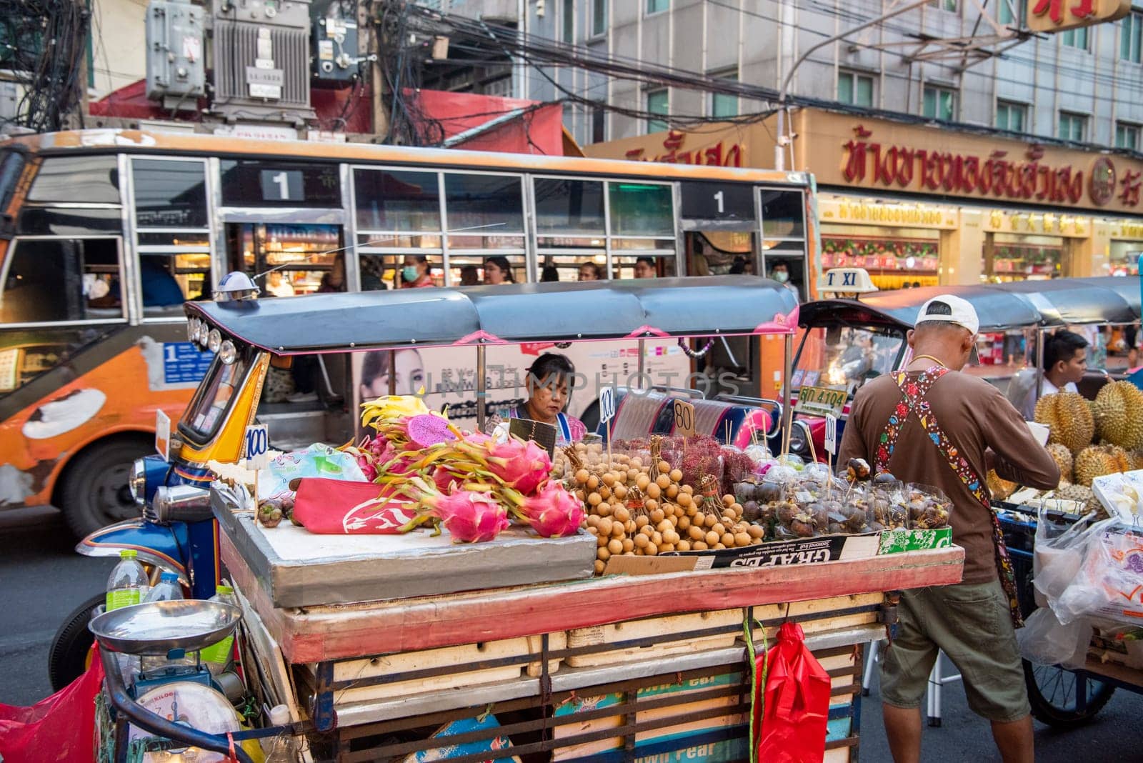 People and Tuk Tuk at Marketstreet on Yaowarat Road in Chinatown in City of Bangkok in Thailand.  Thailand, Bangkok, Dezember, 14, 2024.