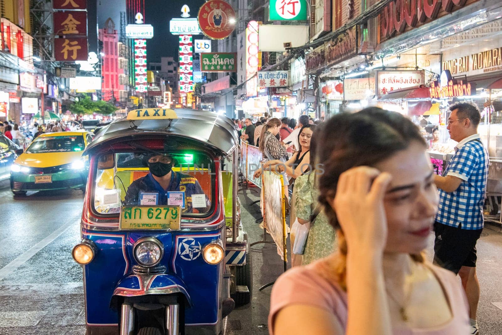 Tuk Tuk and People at Streetmarket on Yaowarat Road in Chinatown in City of Bangkok in Thailand.  Thailand, Bangkok, Dezember,14, 2024.