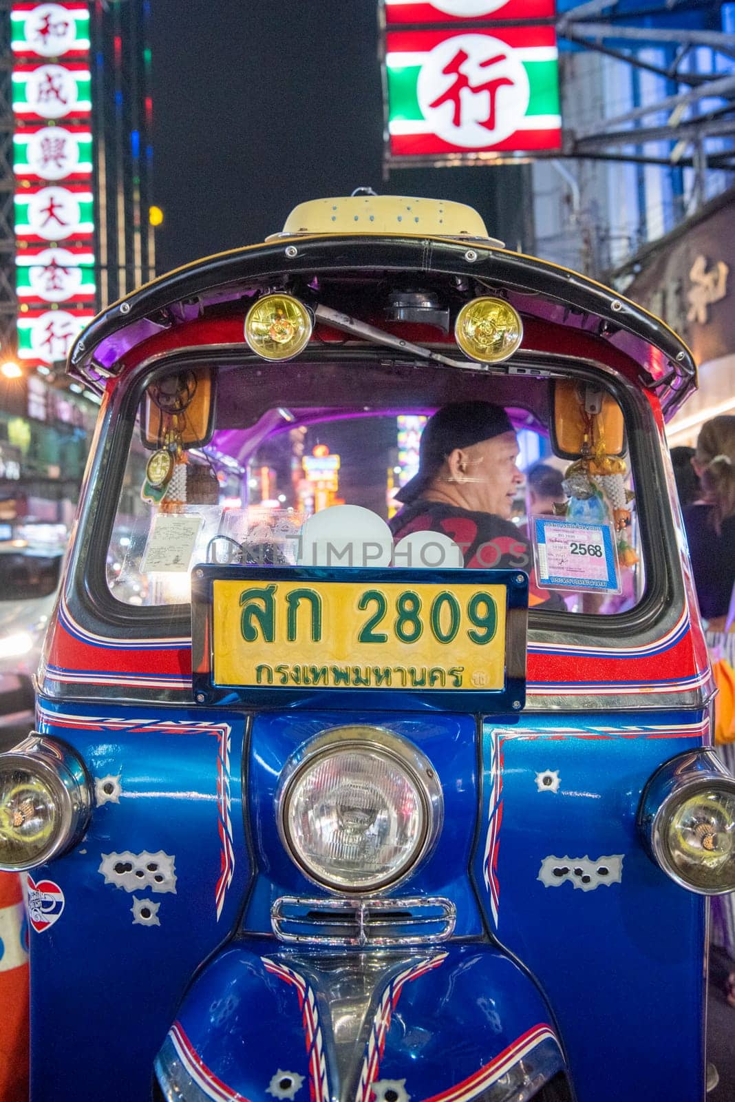 a Tuk Tuk at Marketstreet on Yaowarat Road in Chinatown in City of Bangkok in Thailand.  Thailand, Bangkok, Dezember, 14, 2024.