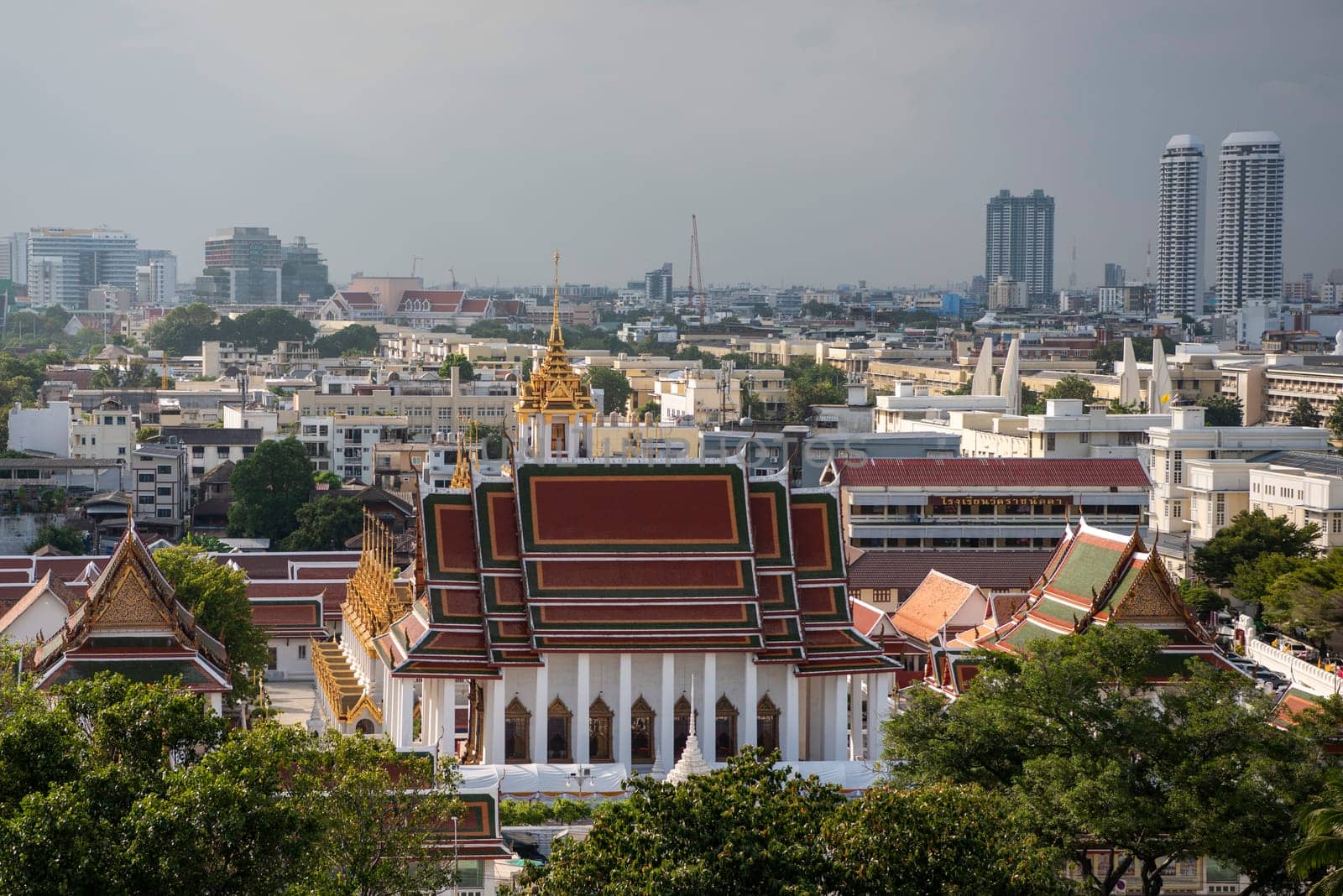 Wat Ratchanatdaram Worawihan with skyline in the City of Bangkok in Thailand.  Thailand, Bangkok, November, 7, 2024.