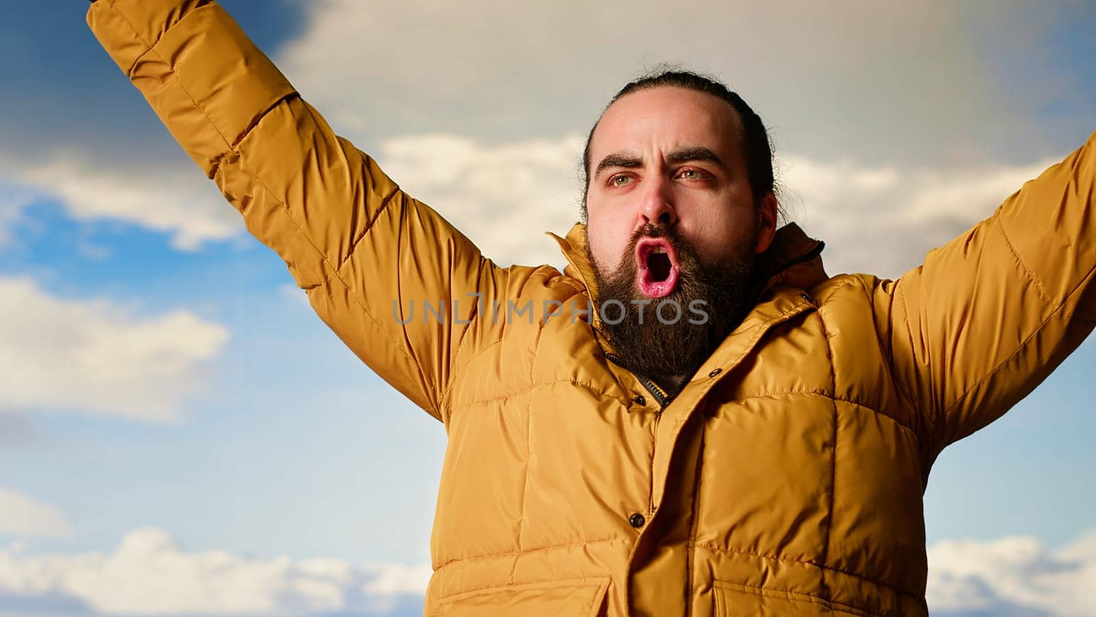 Climber celebrates at a breathtaking mountain summit relishing the scenic view, feeling satisfied and joyful after successful trekking activity. Proud hiker embodies determination. Camera B.