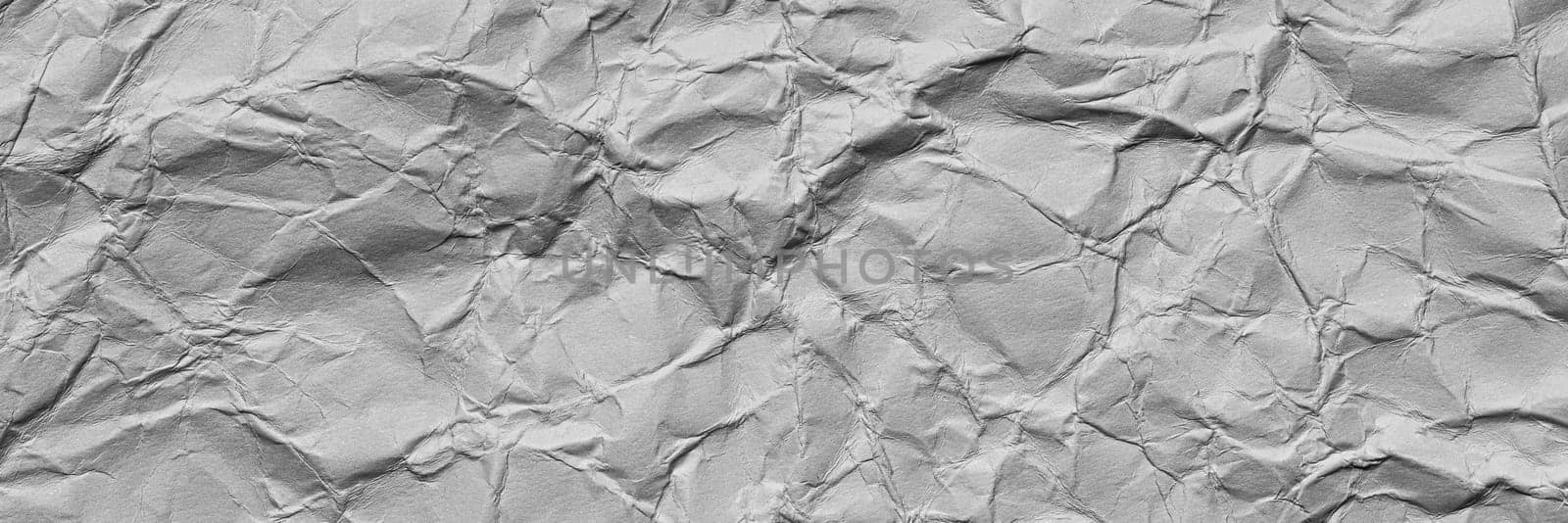 A textured light gray crumpled paper background with natural creases and folds. Ideal for design projects, digital graphics, or creative presentations requiring a vibrant, Long banner