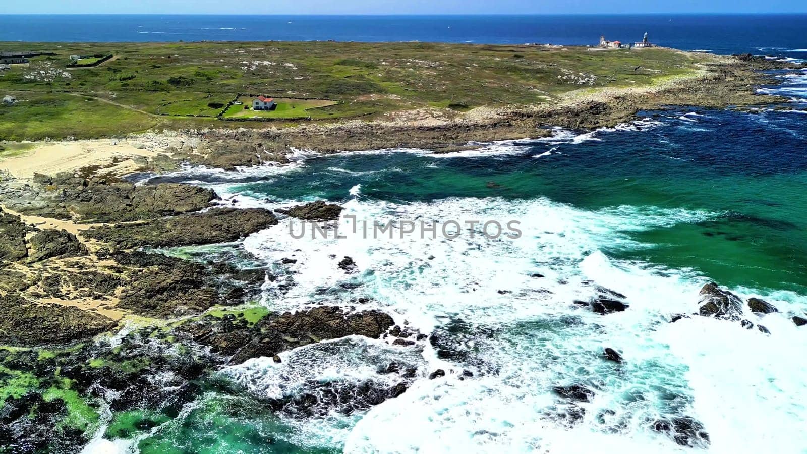 Enjoy stunning aerial views of a rocky coastline, clear turquoise waters, and a picturesque landscape