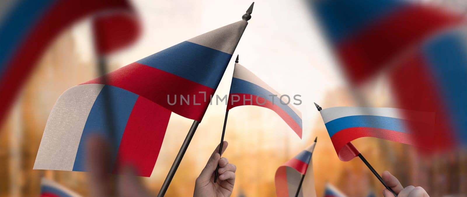 Russia flags in their hands on a blurred urban background. The photo illustration was created without the use of artificial intelligence, only using Photoshop.