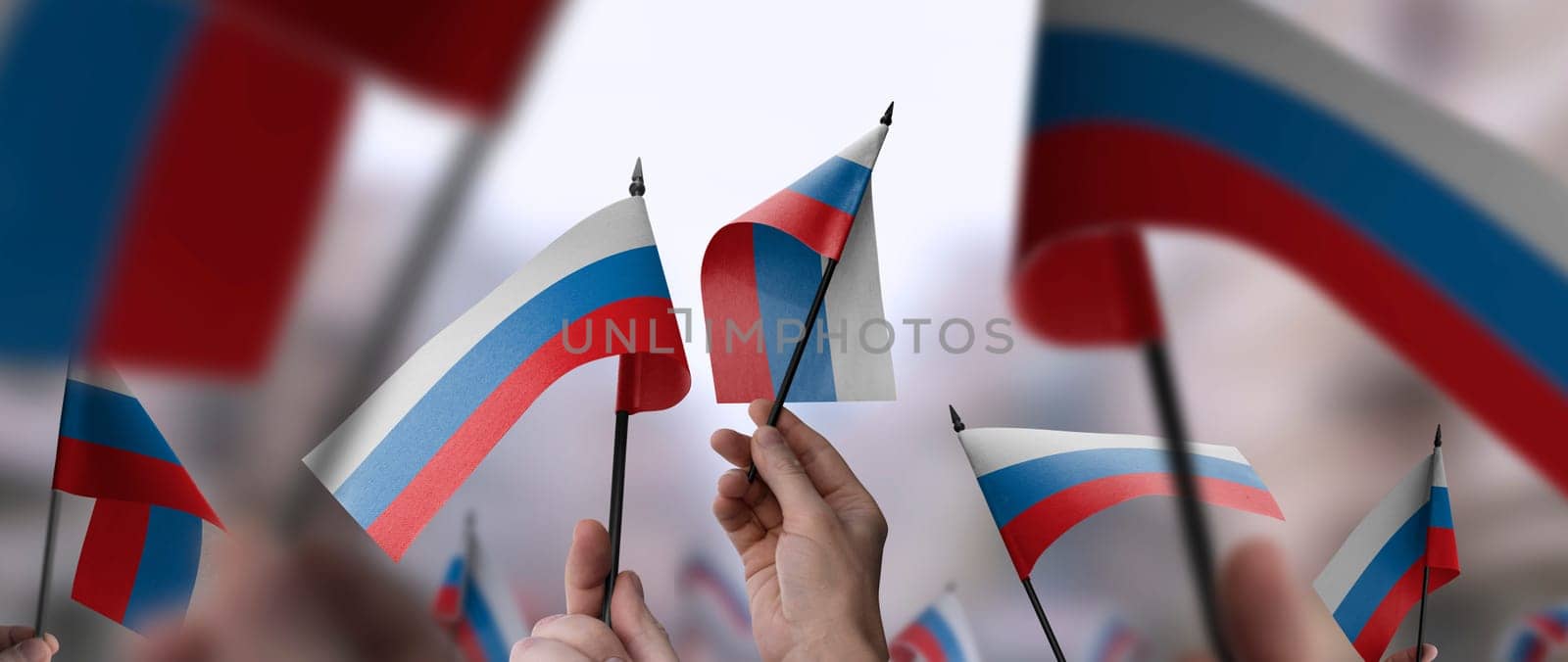 Russia flags in their hands on a blurred urban background. The photo illustration was created without the use of artificial intelligence, only using Photoshop.