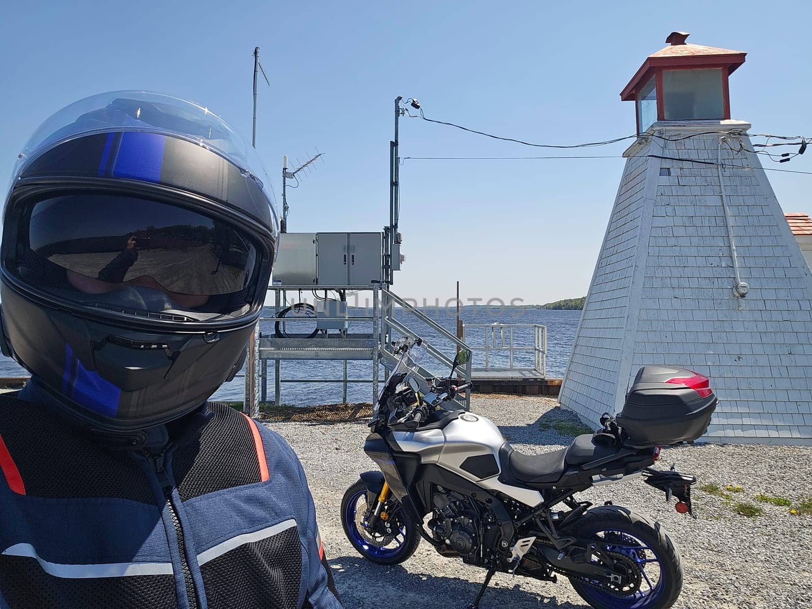Experience a thrilling motorcycle ride along the coast, capturing the essence of freedom and adventure. A scenic journey with a biker and a lighthouse, perfect for summer exploration.