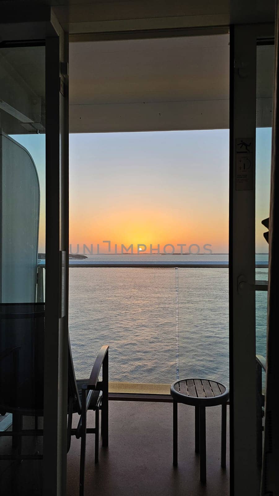 Enjoy a serene sunset ocean view from a cruise ship balcony. This tranquil scene embodies relaxation and travel, perfect for vacation marketing and inspiring wanderlust.