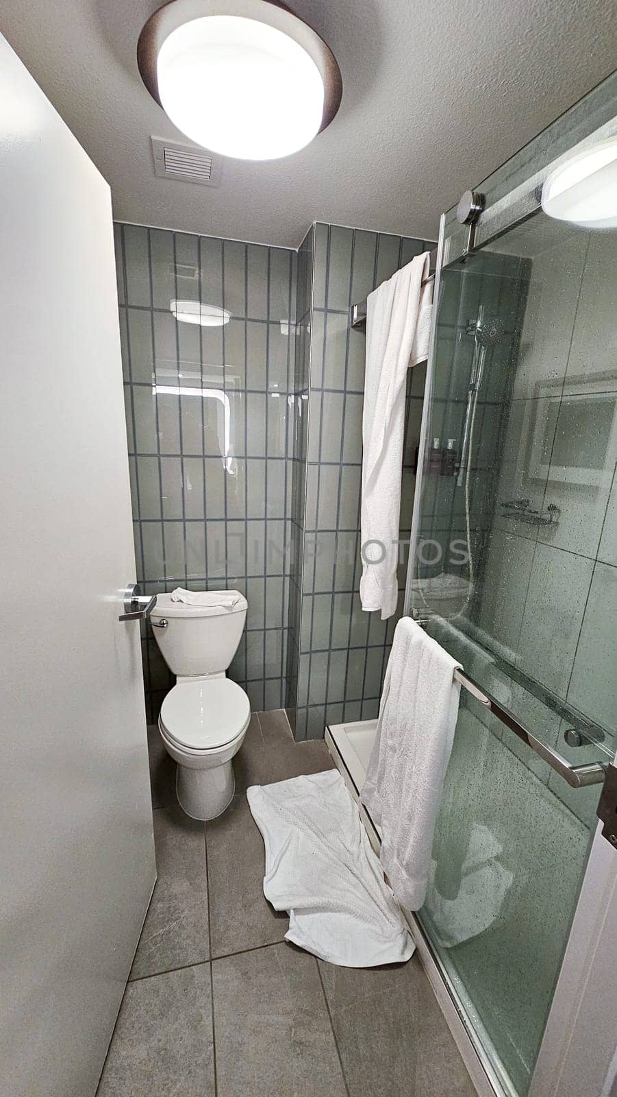 Modern bathroom featuring sleek fixtures, a glass shower, and a white toilet, perfect for real estate listings and home decor inspiration. Ideal for showcasing contemporary design.