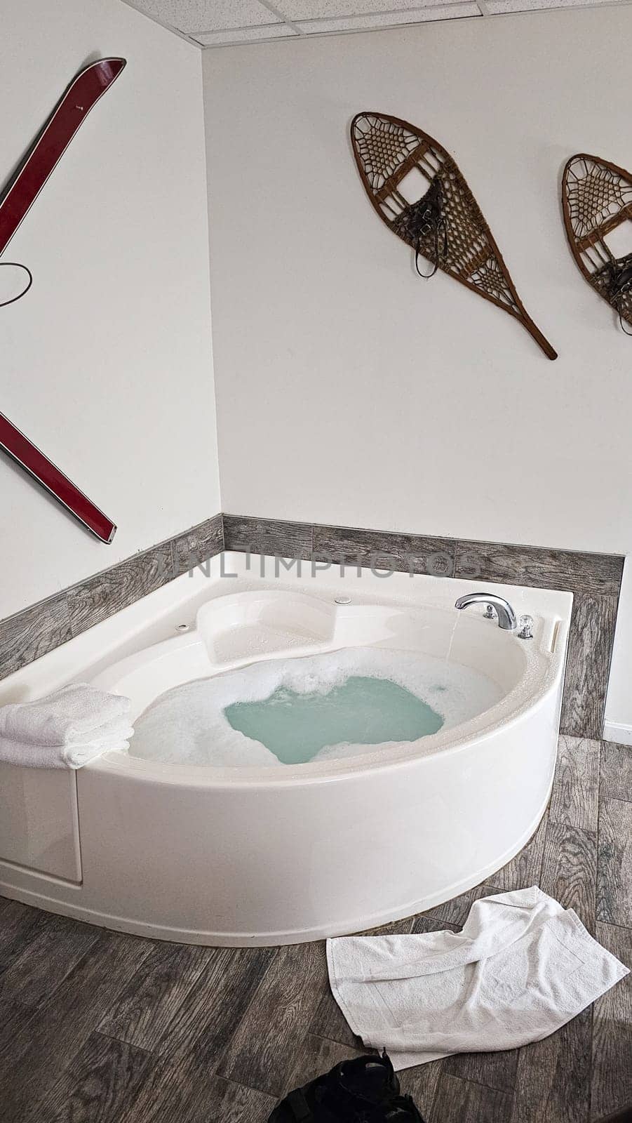 Indulge in relaxation with this cozy corner jacuzzi tub. Bubbles and warm water create a soothing atmosphere, enhanced by charming winter-themed decor. A perfect retreat for unwinding.