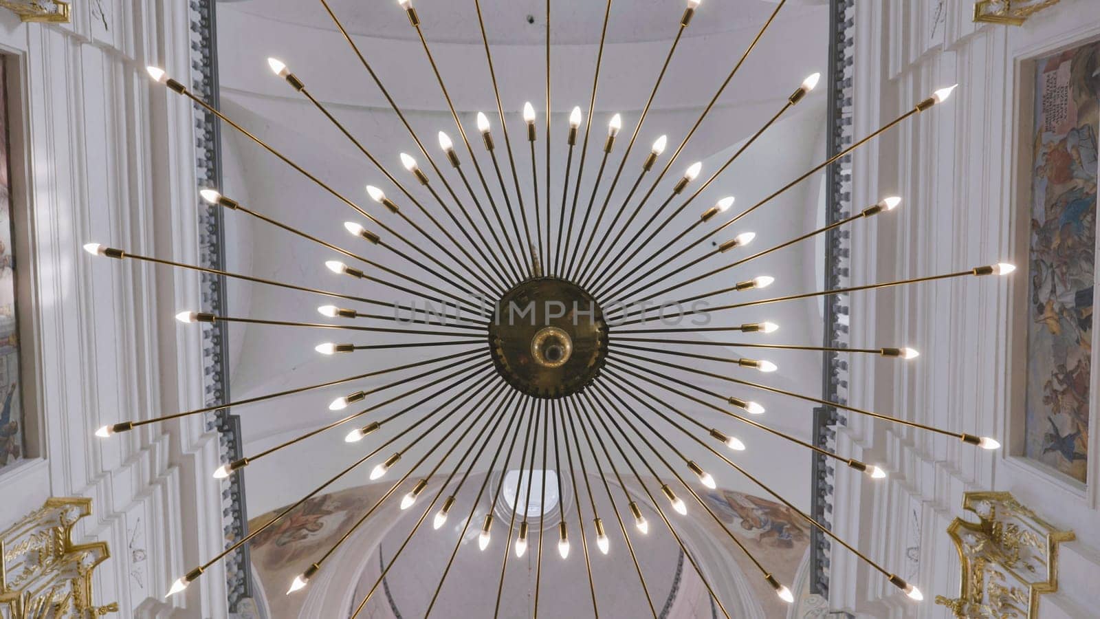 Beautiful ray-shaped chandelier in a Catholic church