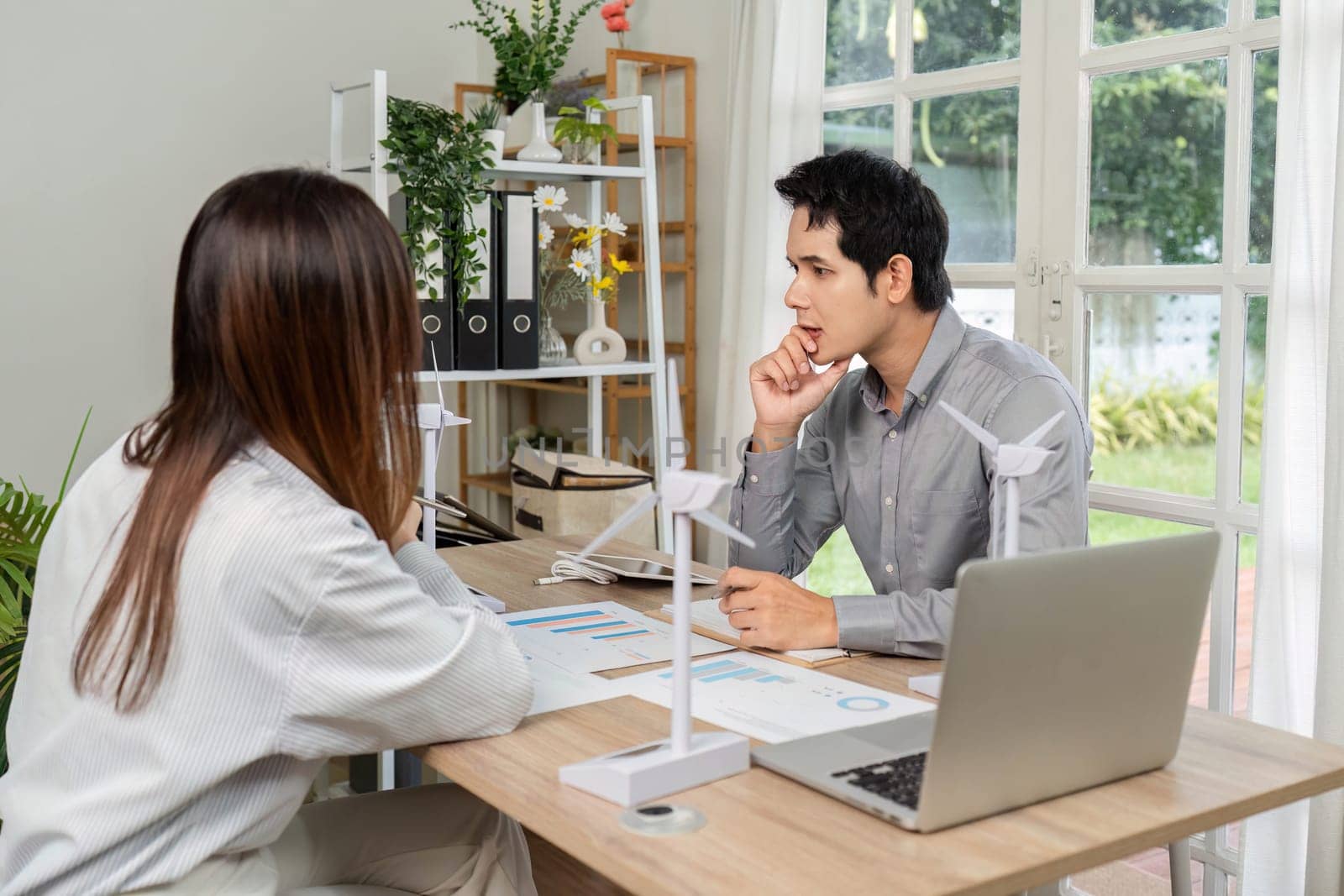 Two professionals engaged in a strategic discussion about ESG goals, fostering a collaborative business environment.
