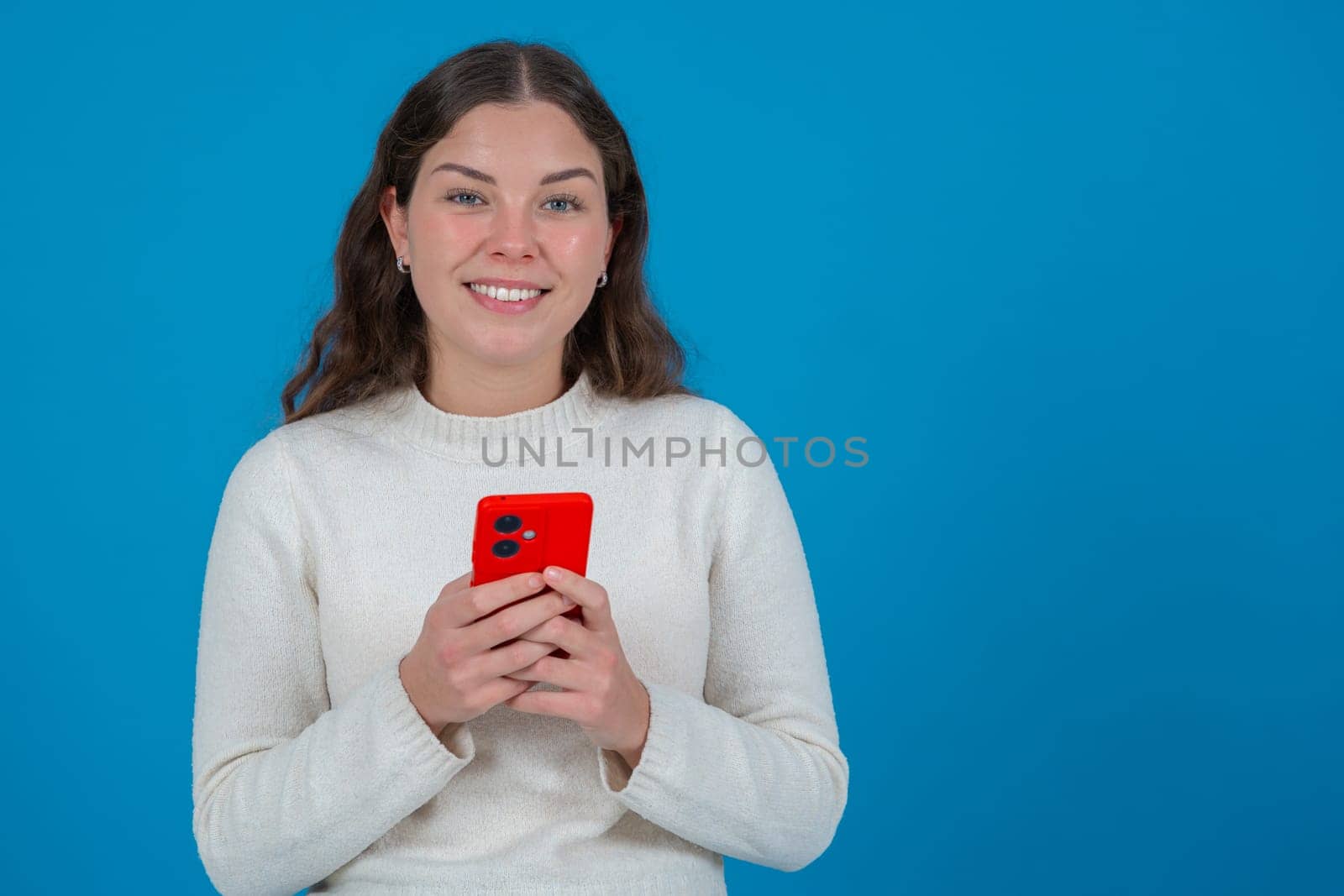 Frustrated man pointing his smartphone screen directly at the camera in an urban setting. His angry expression suggests a problem with the device, app, or digital communication. Copy space