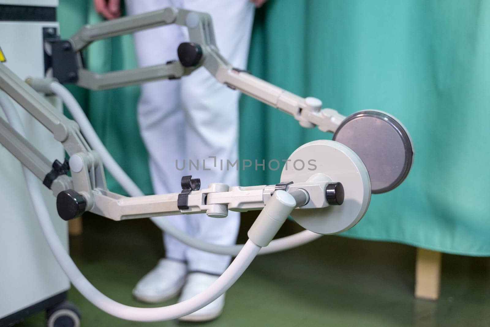 Top down view of a person using a rehabilitation machine for leg therapy, focusing on muscle training and mobility.