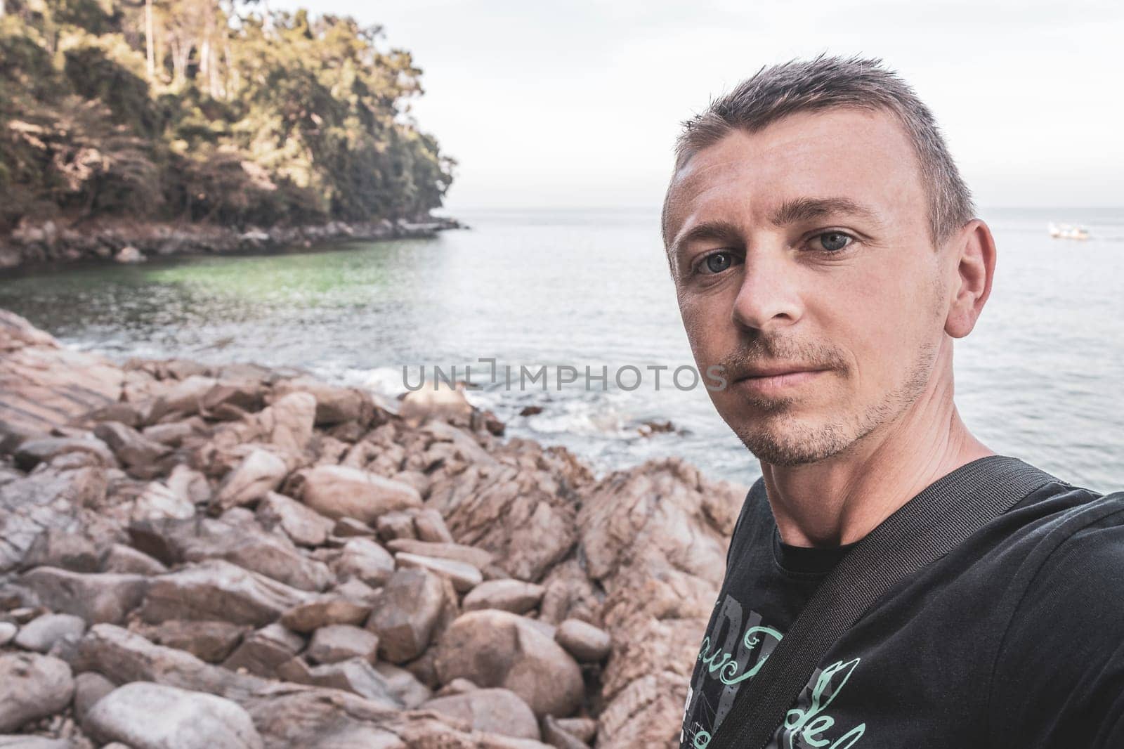 Male young tourist and traveler at beautiful amazing little small sandy beach landscape panorama view of the Khao Lak Lam Ru National Park Khuekkhak Amphoe Takua Pa Phang Nga Thailand.