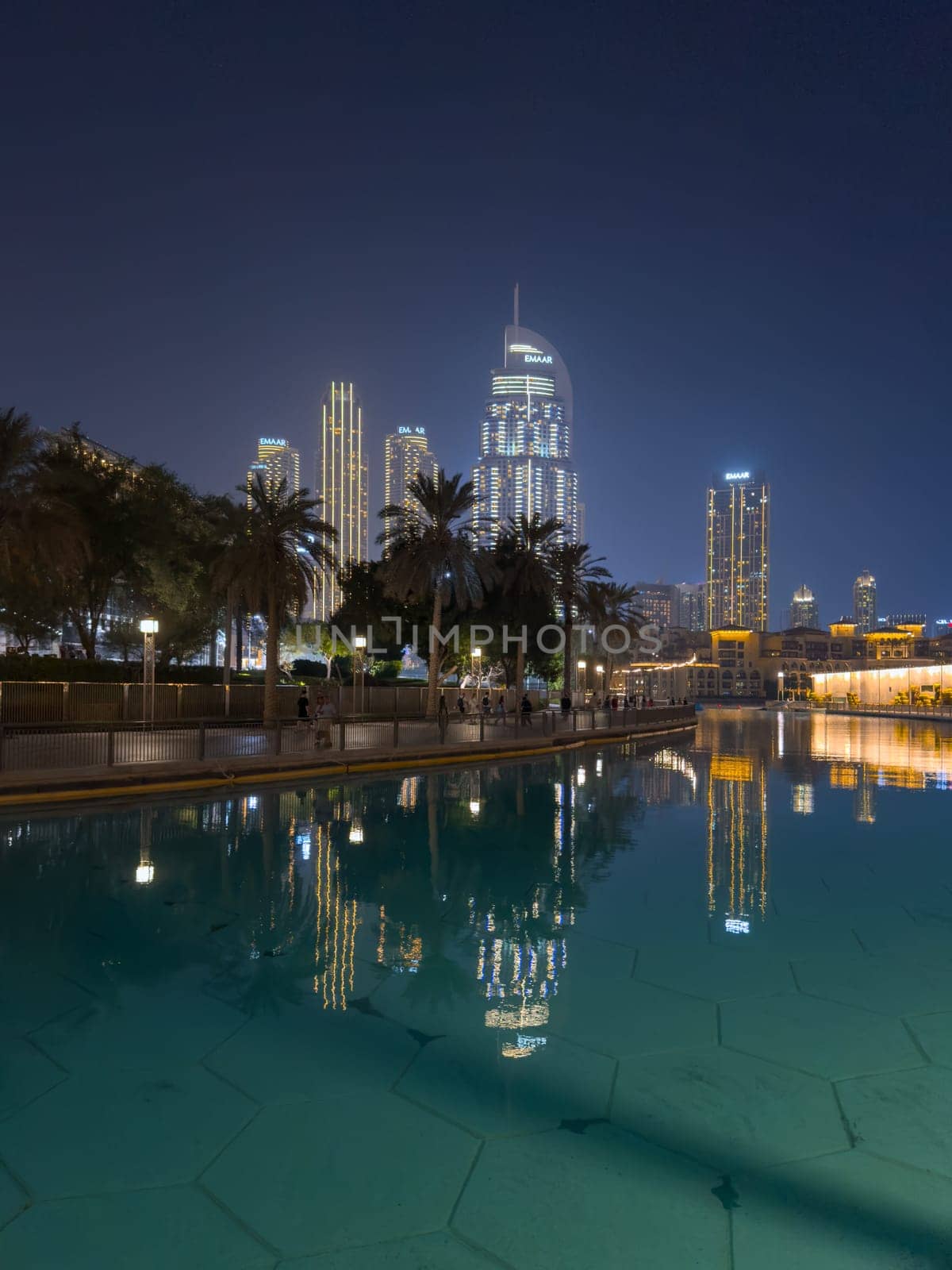 UAE, Dubai, 26 September 2024: The famous shopping center Dubai Mall and Burj Khalifa skyscraper at dusk, Dubai's sights and skyscrapers illuminated at night, palm trees. High quality photo