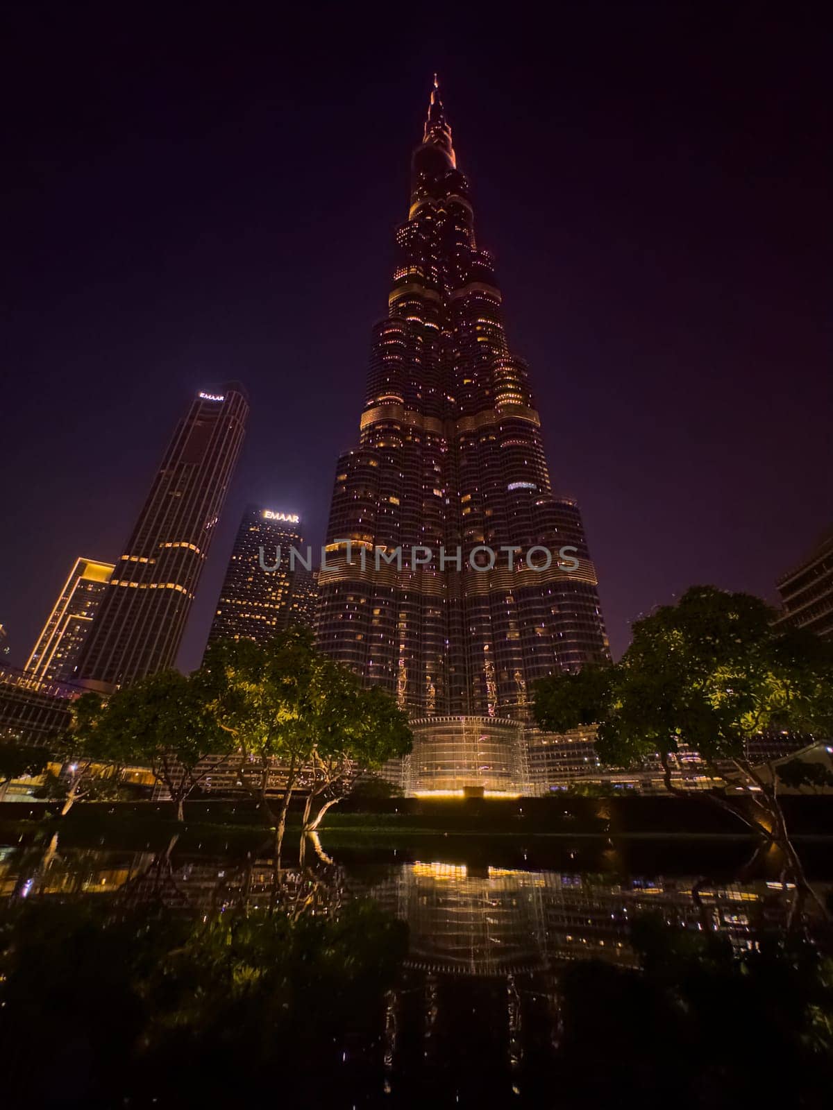 UAE, Dubai, 26 September 2024: The famous shopping center Dubai Mall and Burj Khalifa skyscraper at dusk, Dubai's sights and skyscrapers illuminated at night, palm trees. High quality photo