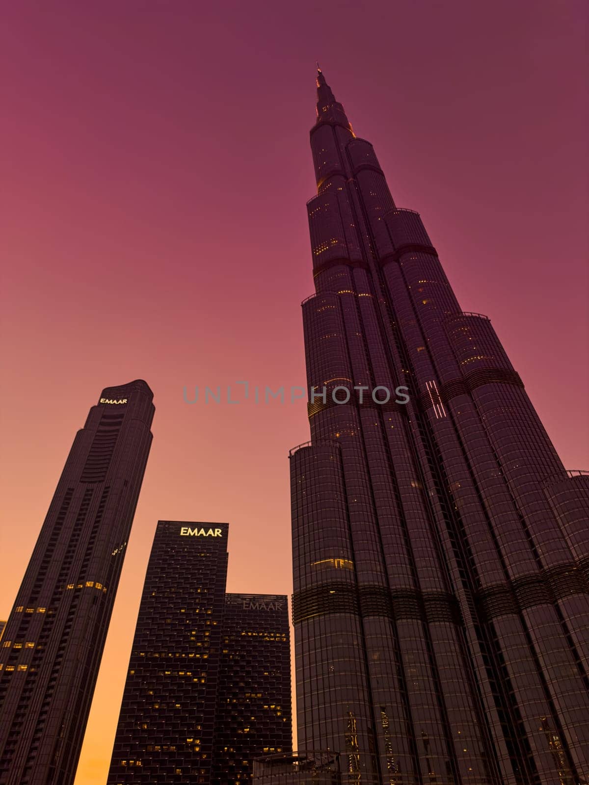 UAE, Dubai, 26 September 2024: The famous shopping center Dubai Mall and Burj Khalifa skyscraper at dusk, Dubai's sights and skyscrapers illuminated at night, palm trees. High quality photo