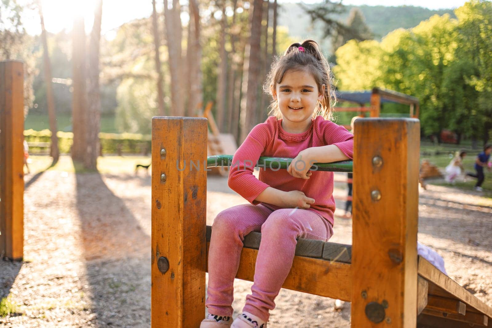 Active cute little girl on the playground.