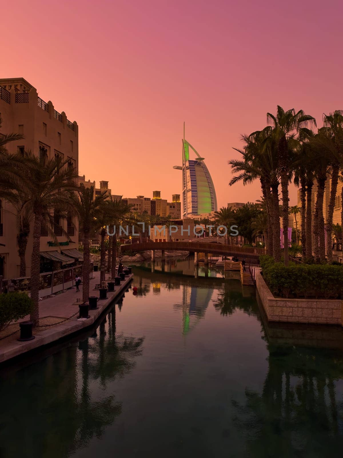 UAE, Dubai, 23 September 2024: night illumination of luxury hotel The Burj Al Arab Jumeirah Resort is located on its own island, with suites overlooking the sea, restaurants and a spa, embankment. High quality photo