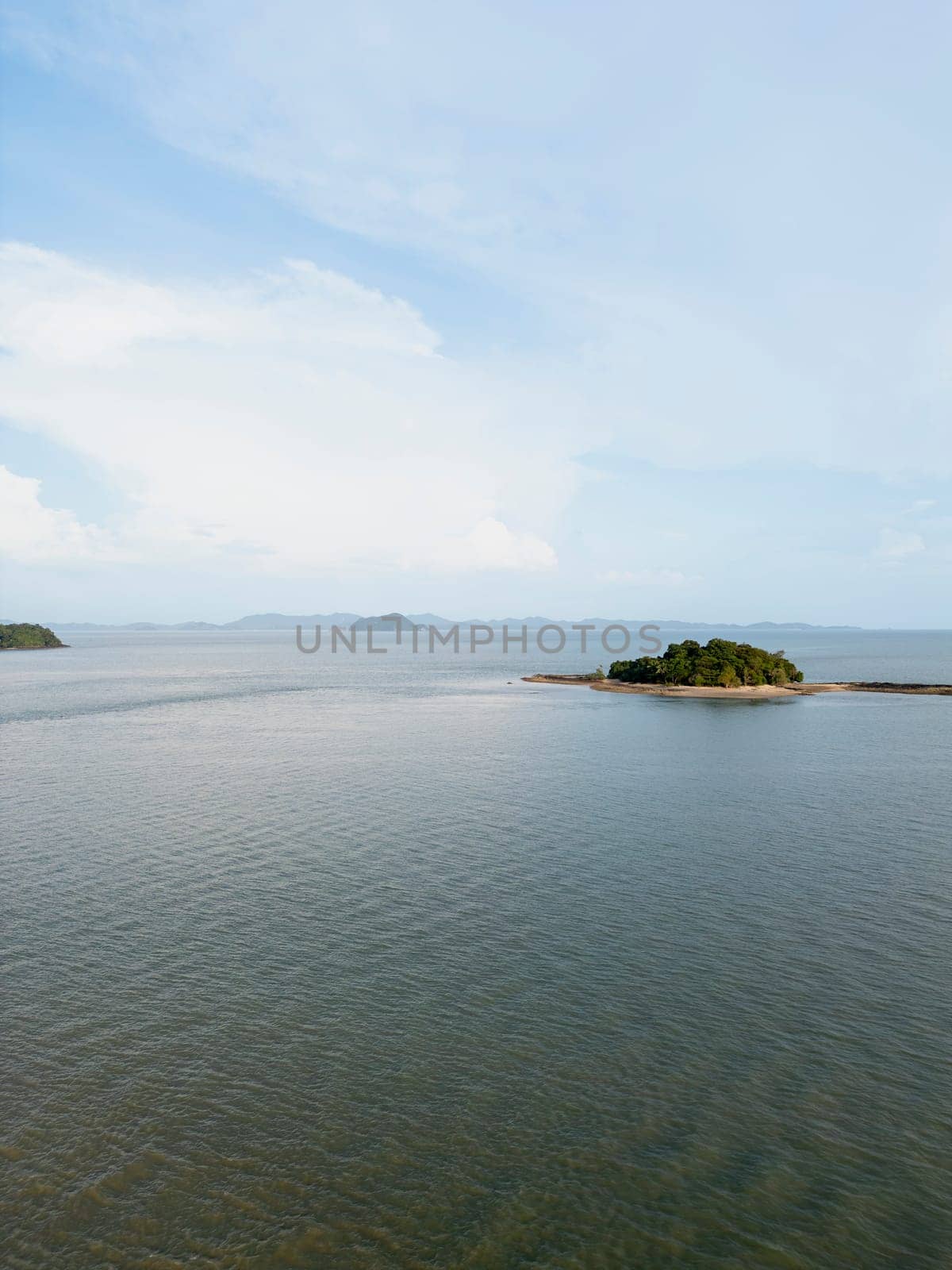 Drone shot of island resorts with sandy beaches and clear ocean waves, tranquil seaside escape with a blue sky. Beautiful Thailand coastline natural beauty as a tropical paradise.