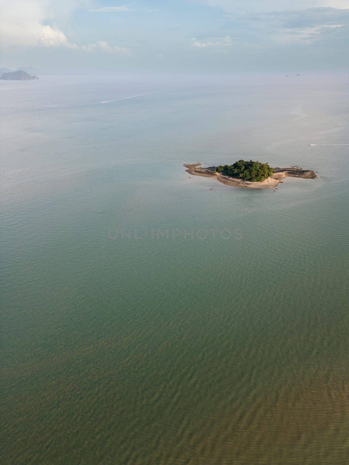 Picturesque aerial view of the Thailand coastline with golden sand and palm trees, glowing in bright sunlight on the Thai paradise landscape. Tropical travel destination at the seaside.