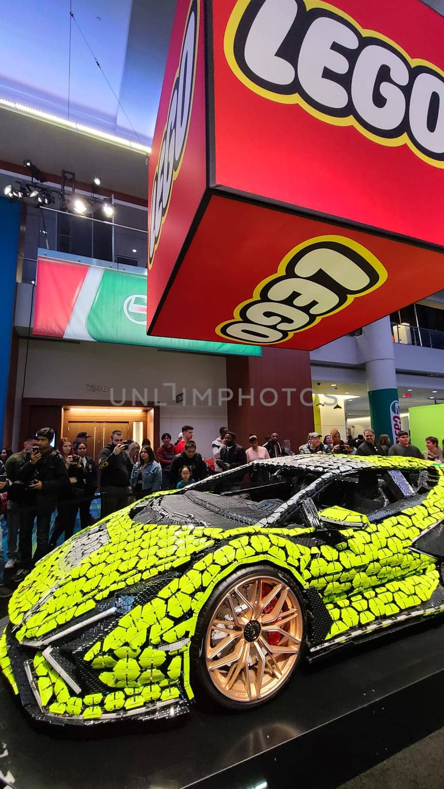 Toronto, ON Canada - 02.19.2023: Crowd Enthralled by Large Scale Lego Vehicle Model at Automotive Exhibition.