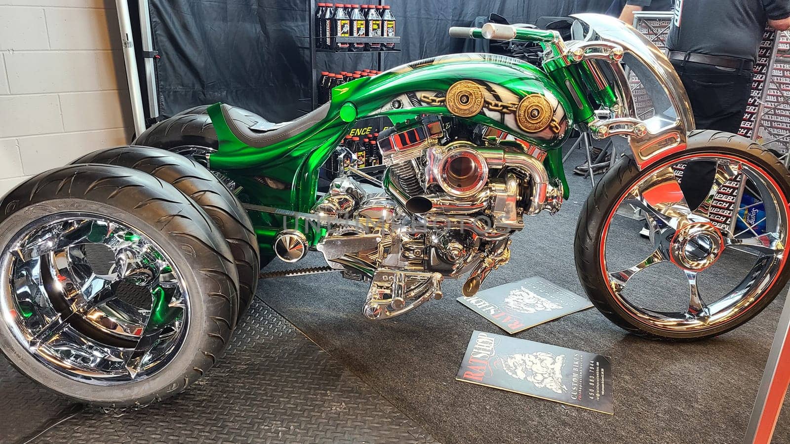 Montreal, QC Canada - 02.25.2023: Custom Trike Motorcycle with Chrome and Green Paint Job on Display, Mesmerizing Design.