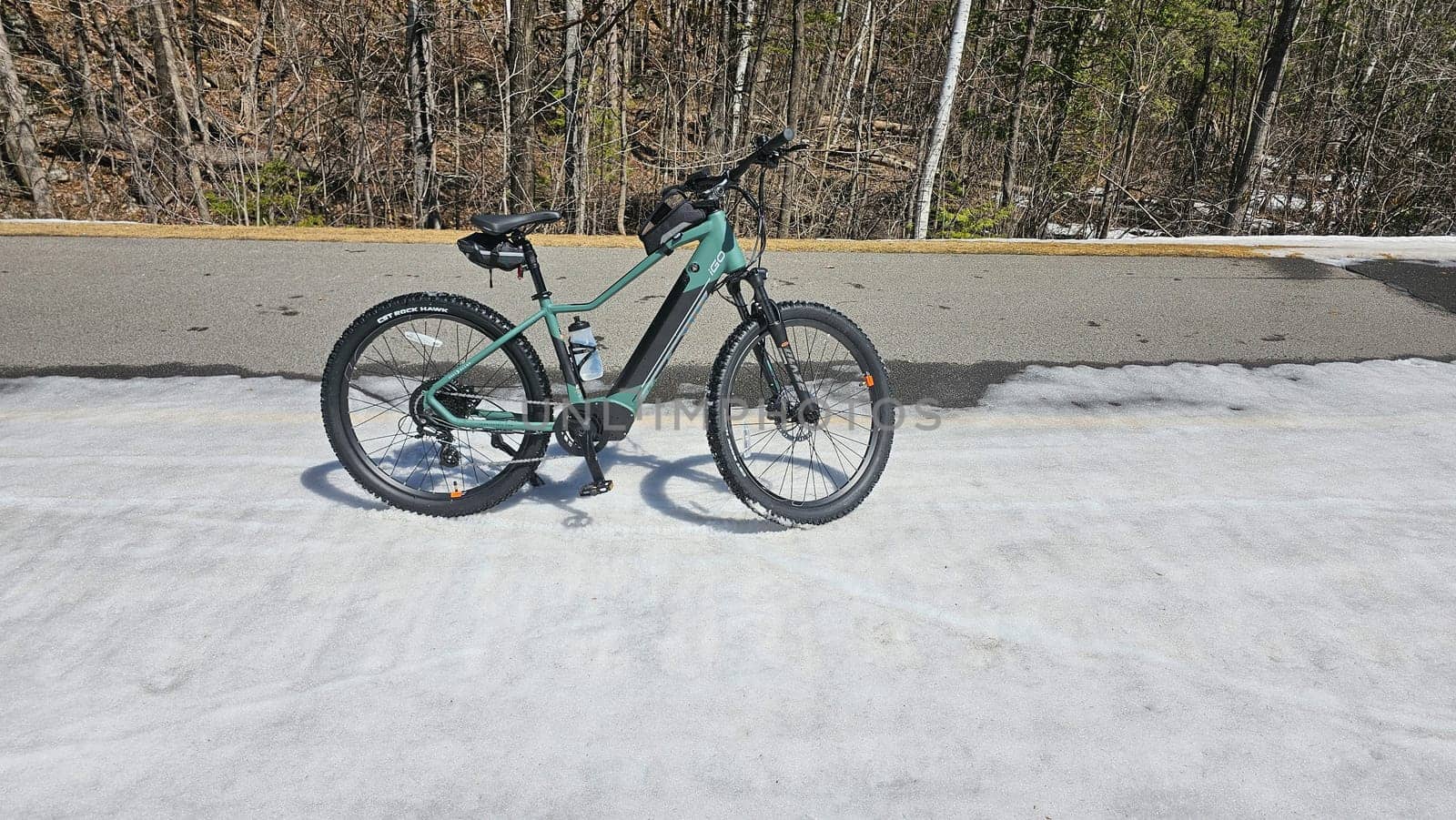 Ottawa, ON Canada - 04.15.2024: Adventure Awaits Mountain iGo electric Bike Ready for a Ride on a Snowy Path, Outdoor Exploration.