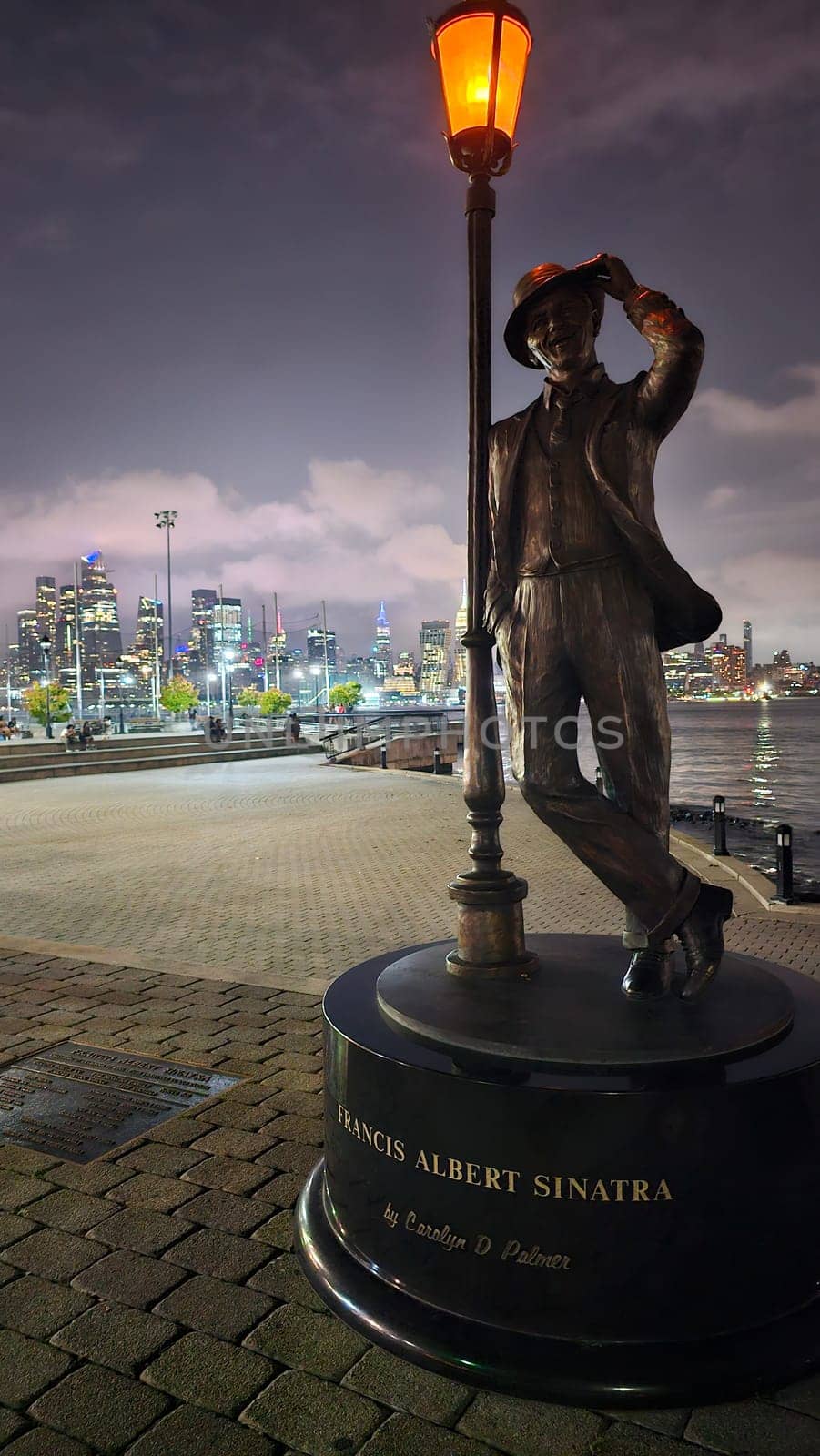 New York, NY USA - 07.08.2023: Francis Albert Sinatra Statue Illuminates Hoboken Waterfront at Nightfall, New Jersey.