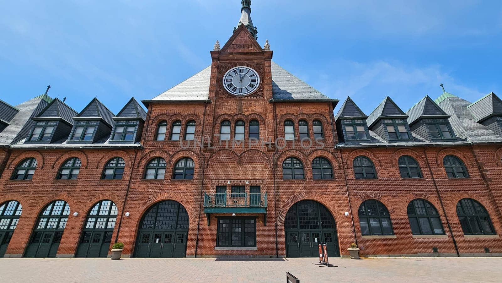 New York, NY USA - 07.07.2023: Historical Train Station Architecture with Clock Tower and Arched Windows, Sunny Day.