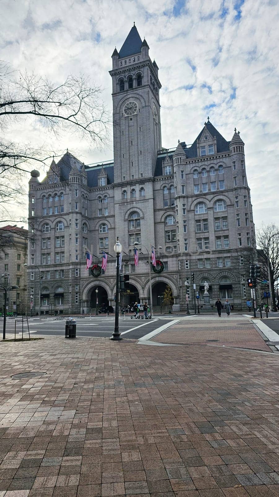 Washington D.C. USA - 12.29.2023: Historic Landmark Building in Washington D.C. with Clock Tower and American Flags.